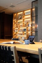 A modern interior with a wooden table, chairs, and a laptop.