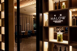 A modern interior with a sign reading "HALOW MODERN CHINESE BRASSERIE".