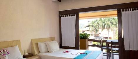 A hotel room with two beds, a wooden ceiling, and a view of palm trees outside.
