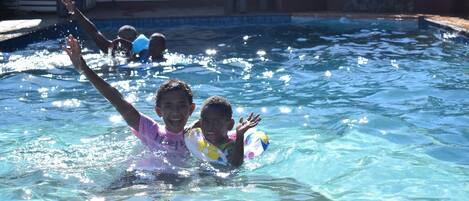 A swimming pool with clear water and visible ripples.