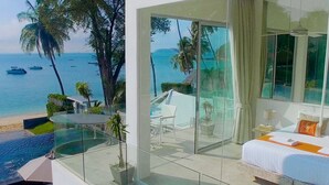 A modern hotel room with a glass balcony overlooking a beach and the sea. - FREE $1600 Daily Luxury Pack - 16-Bed Beachfront Villa - Private Pool, Spa & Gym (Tambon Vichit, Ampur Muang)