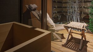 A wooden deck with a built-in seating area and a glass wall. - Kairos by the Mountain (Hakuba)