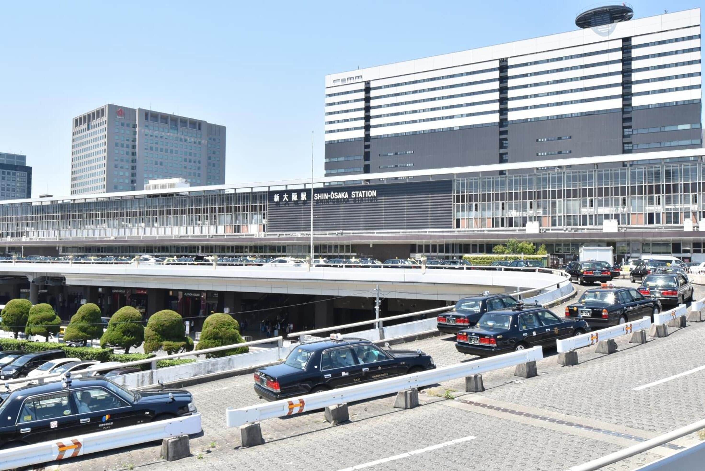 A modern building with a sign reading "SHIN-OSAKA STATION".