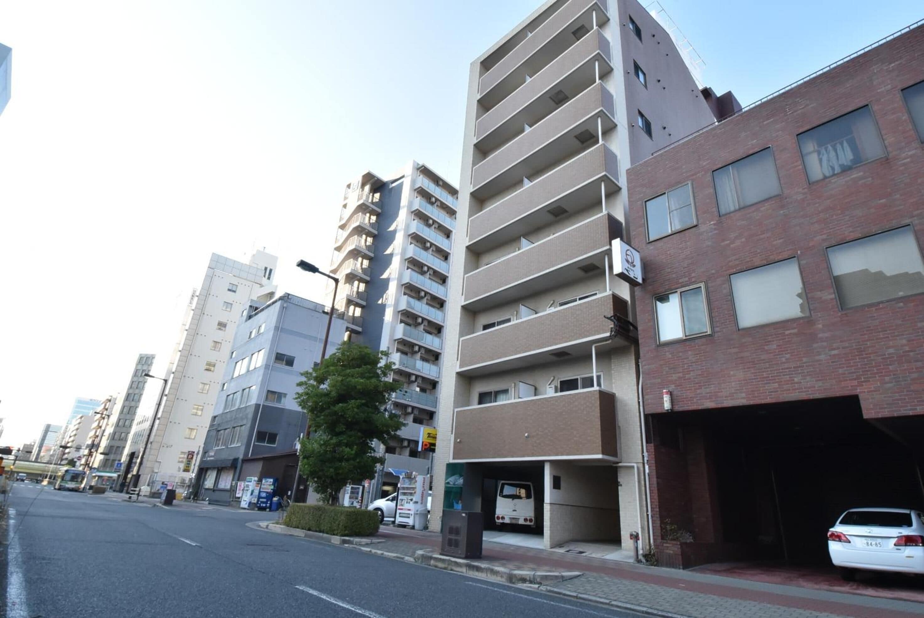 A multi-story building with a parking garage on the ground level.