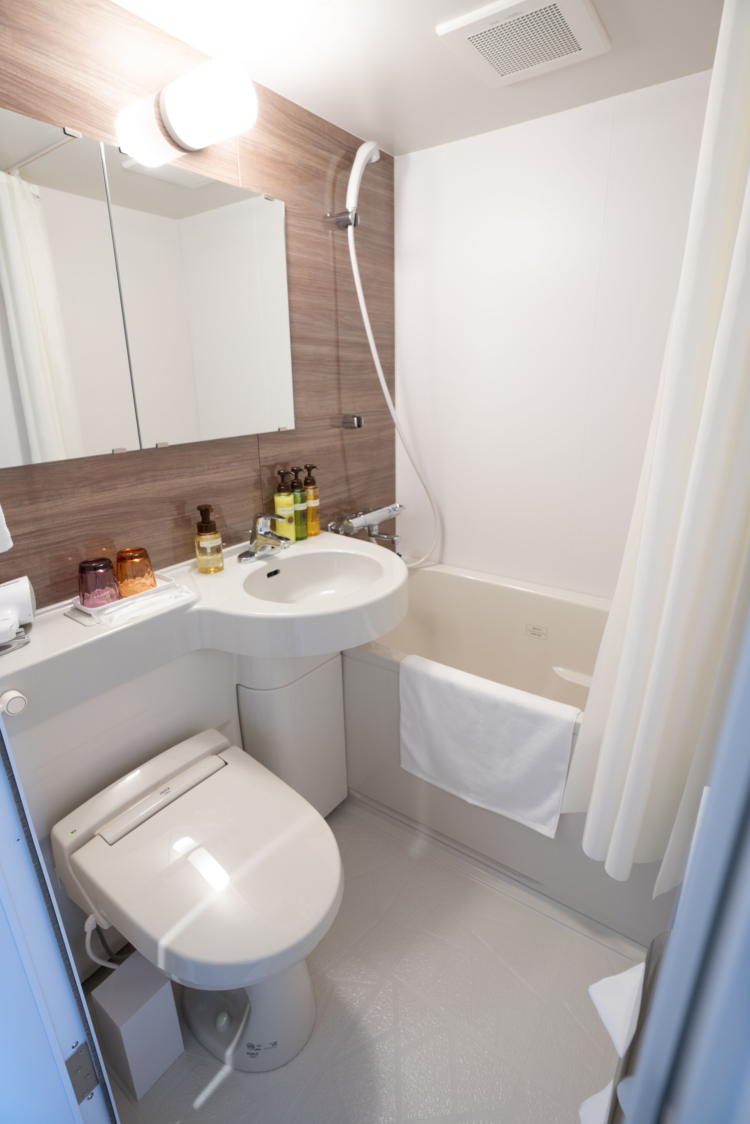 hair dryer, slippers, bidet, towels