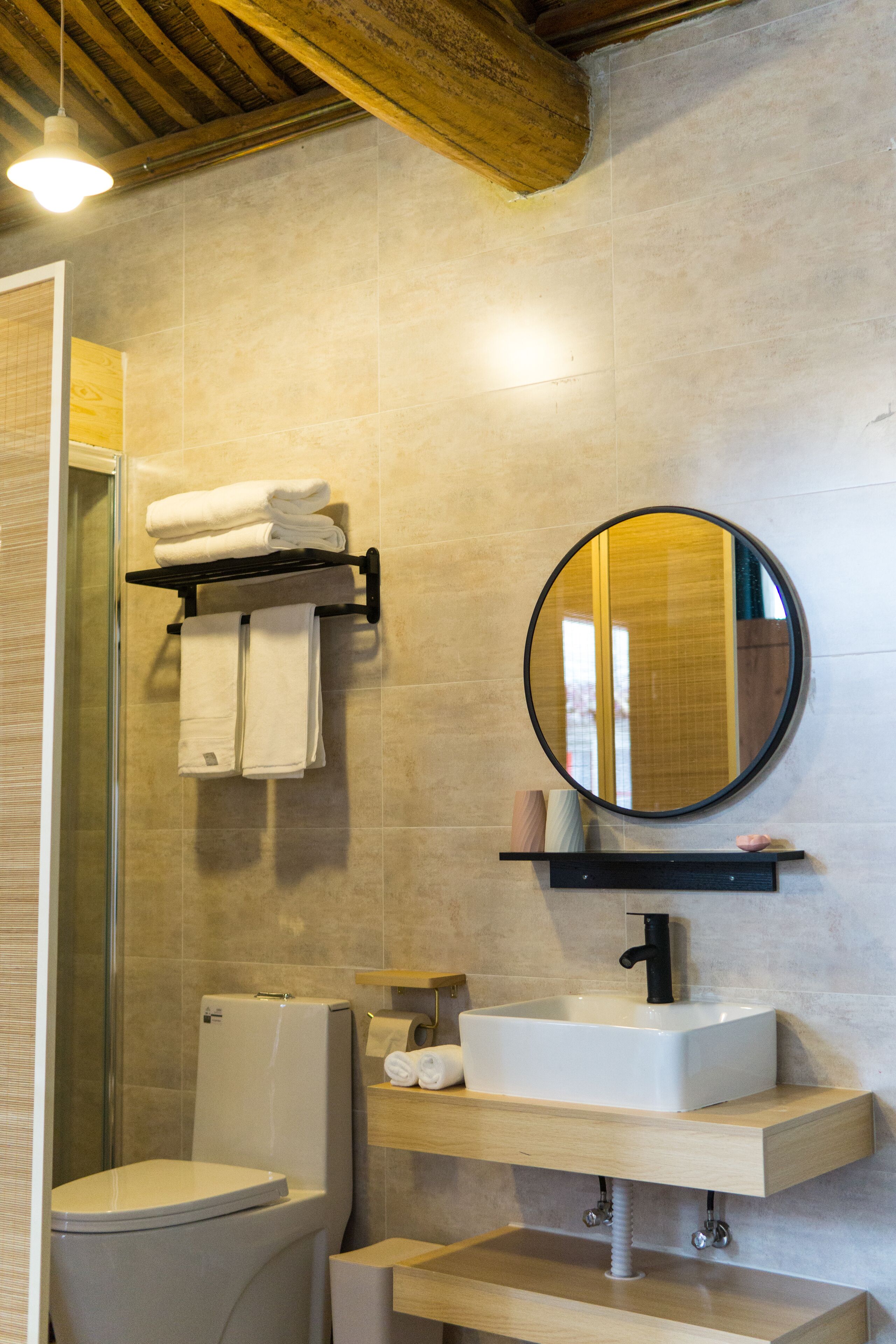 A modern bathroom with a toilet, sink, and mirror.