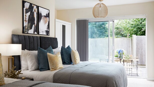A bedroom with a large bed, a headboard, a bedside table with a lamp, and artwork on the wall. - Watford WD17 - Stunning 2 Bed Flat near Watford Junction (Watford)