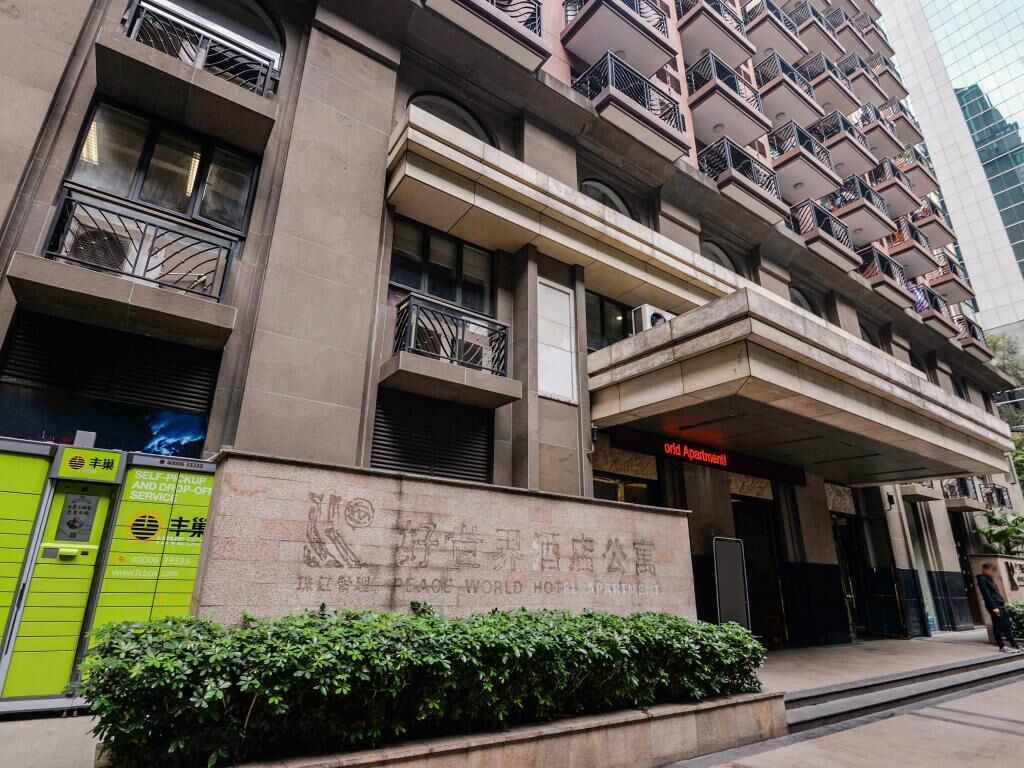A multi-story hotel with a sign indicating it is a "Peace World Hotel."
