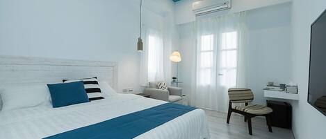 Un dormitorio moderno con una cama grande, un escritorio y una silla.