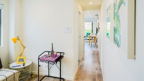 A narrow hallway with a round table, a lamp, and a small Eiffel Tower model on a stand. - U201 Brunswick Living Top flor Balcony Close to APT n CBD FreeWifi Tram Doorstep (Brunswick West)
