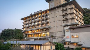 A multi-story hotel with a modern architectural design, featuring balconies and large windows. - Yamamura Annex (Nagato)