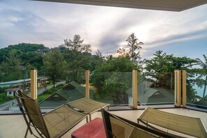 A balcony with a view of a residential area, including houses and trees. - BangTao Beachfront by Lofty (Choeng Thale)