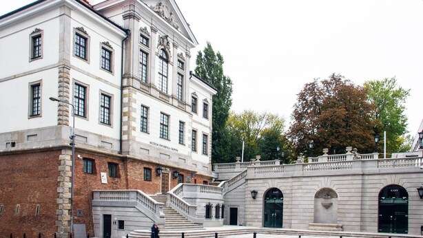 A historic building with classical architecture, featuring a grand staircase, multiple windows, and a prominent entrance. - Kopernika Srodmiescie Apartment (Warsaw)