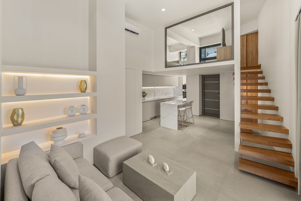 The Living Room, Dining Area, and Staircase Leading to the Mezzanine