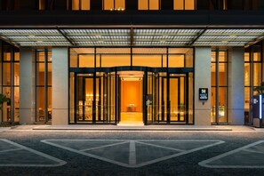A hotel entrance with a glass facade, a revolving door, and a sign indicating it is a Hyatt hotel. - Hyatt Place Changchun Jingyue (Changchun)