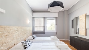A modern bedroom with two beds, a large mirror, and a ceiling light. - Acropoli's Luxury Apartment (Athens)