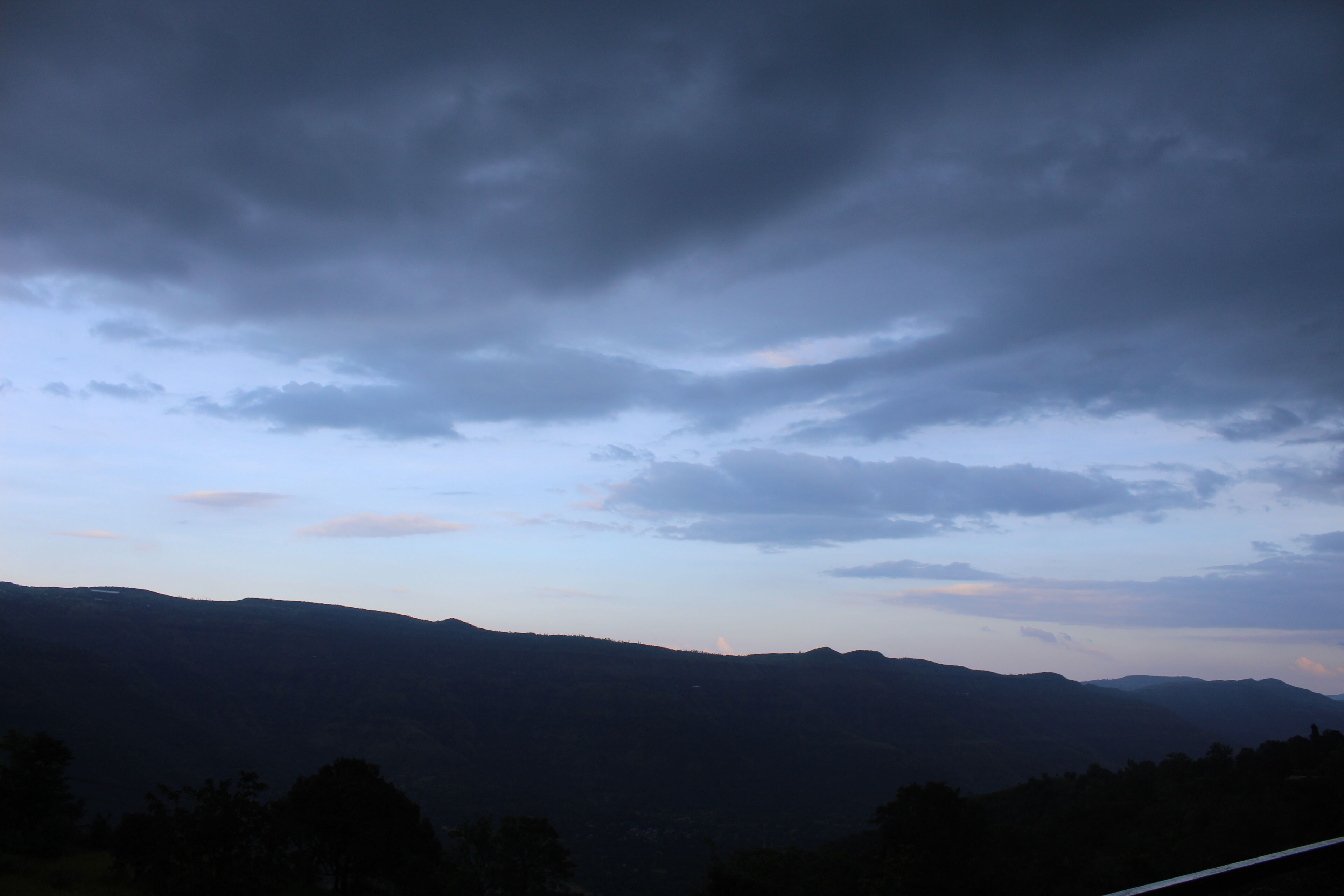A mountainous landscape with a cloudy sky.