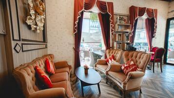 A cozy living room with two sofas, a coffee table, and a bookshelf.