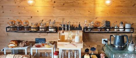A bakery counter with bread, pastries, and jars of ingredients.