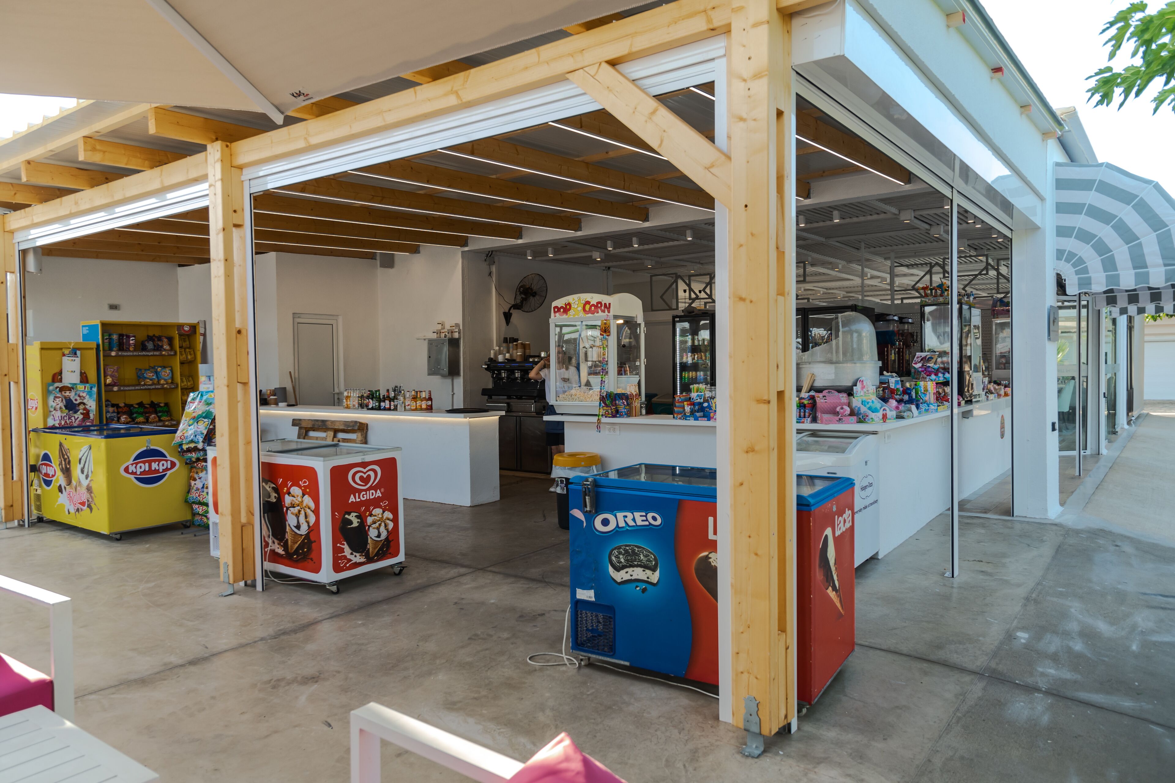 A food court with kiosks selling ice cream and snacks.