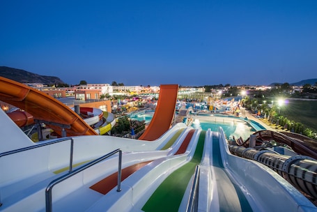 A water park with multiple water slides and a swimming pool.