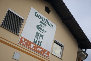 A building with a sign that reads "Gostilna."