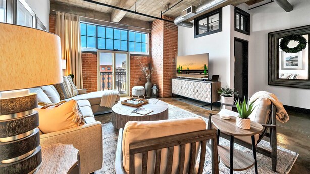 A spacious living room with a large window, a fireplace, and a dining area. - Urban Oasis In Downtown Waco; short walk to Silos (Waco)