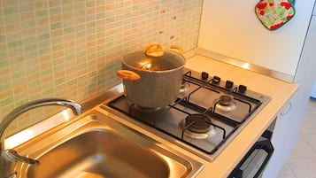Apartment, 1 Bedroom (Bilocali Savonarola) | Private kitchen | Full-sized fridge, oven, stovetop, cookware/dishes/utensils