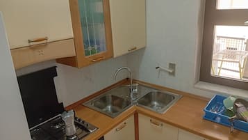 Apartment, 2 Bedrooms (Trilocali Baia Blu) | Private kitchen | Full-sized fridge, oven, stovetop, cookware/dishes/utensils