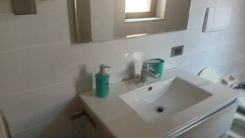Apartment, 2 Bedrooms (Trilocali Baia Blu) | Bathroom | Shower, rainfall showerhead, bidet