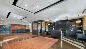 A spacious lobby with a reception desk, seating area, and a bookshelf. - Best Western Plus Lakeview Hotel (Madison)
