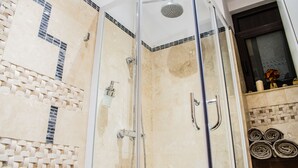 A glass-enclosed shower with a handheld showerhead and a wall-mounted faucet. - ❤️ CityCenter Athenaeum Exquisite 1BD Apartment ❤️ (Sector 1)
