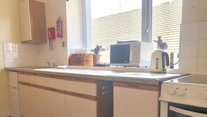 A kitchen with a microwave, toaster, and oven.