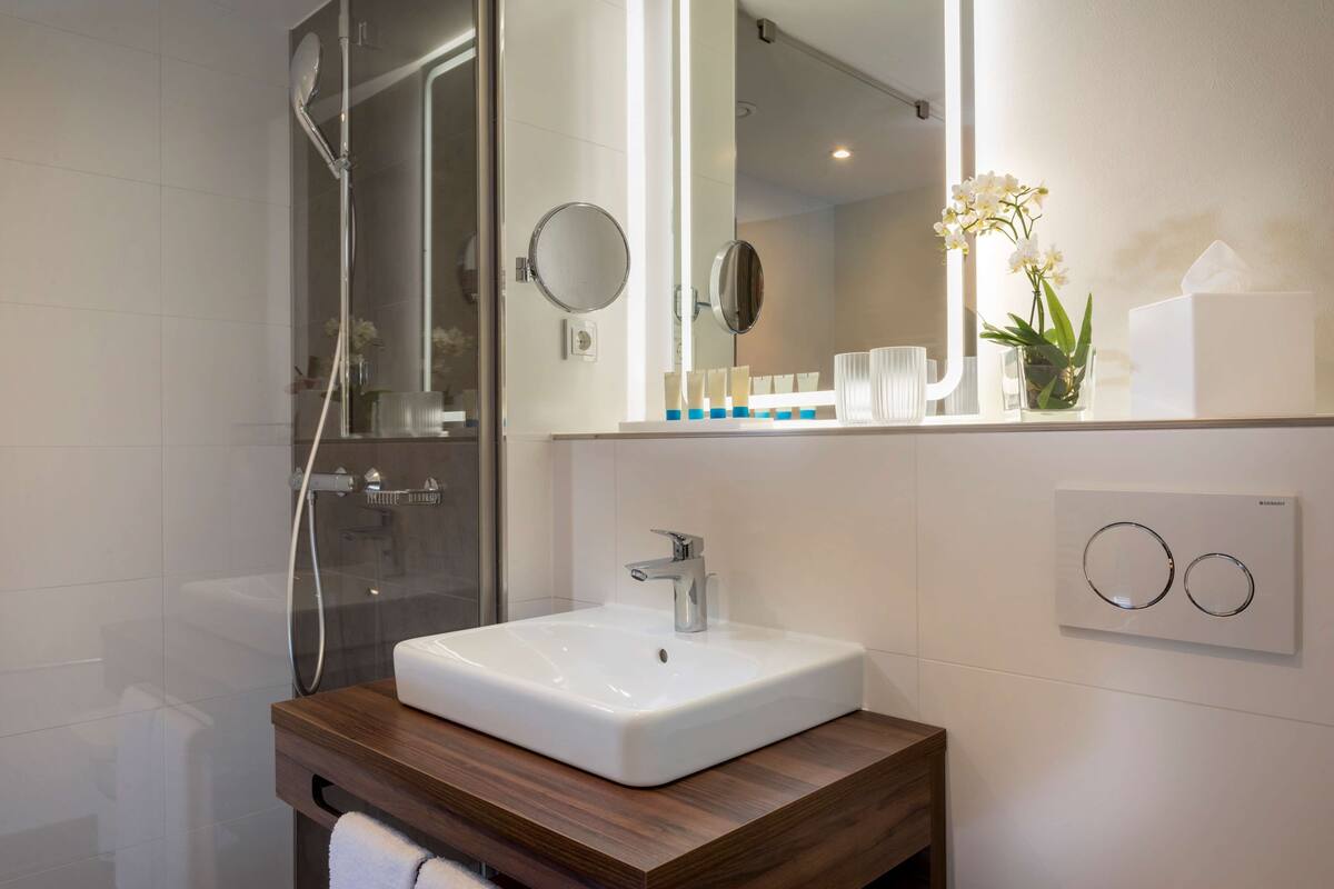 shower, rainfall showerhead, hair dryer, towels