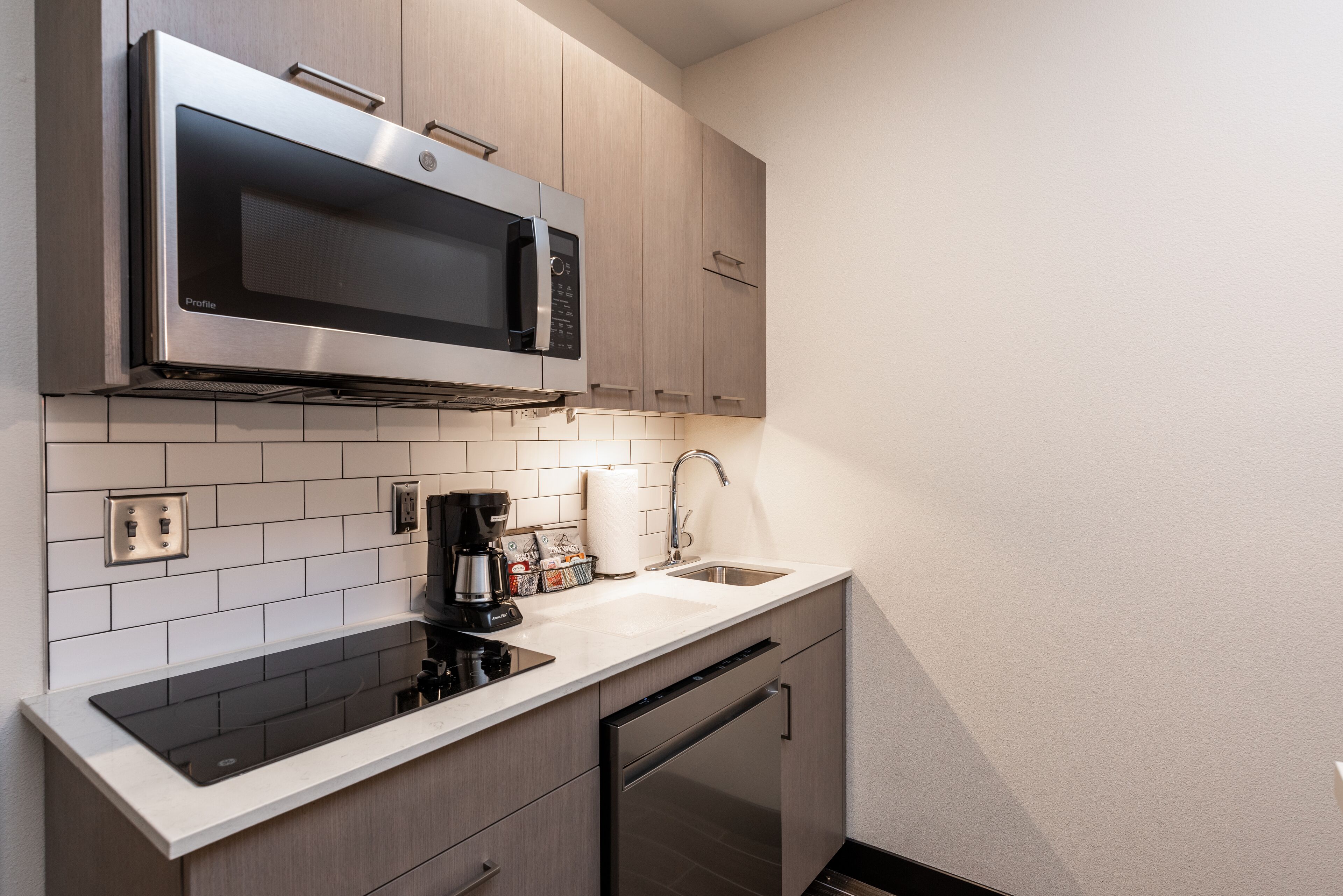 full-sized fridge, microwave, coffee/tea maker, cookware/dishes/utensils