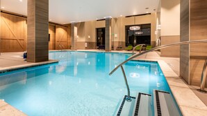 A modern indoor swimming pool with clear water, surrounded by wooden panel walls and a metal handrail. - Hyatt House Nashville Downtown/Convention Center (Nashville)