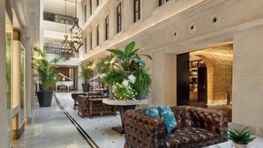 A spacious lobby with a marble floor, leather sofas, and potted plants. - JW Marriott Istanbul Bosphorus (Istanbul)