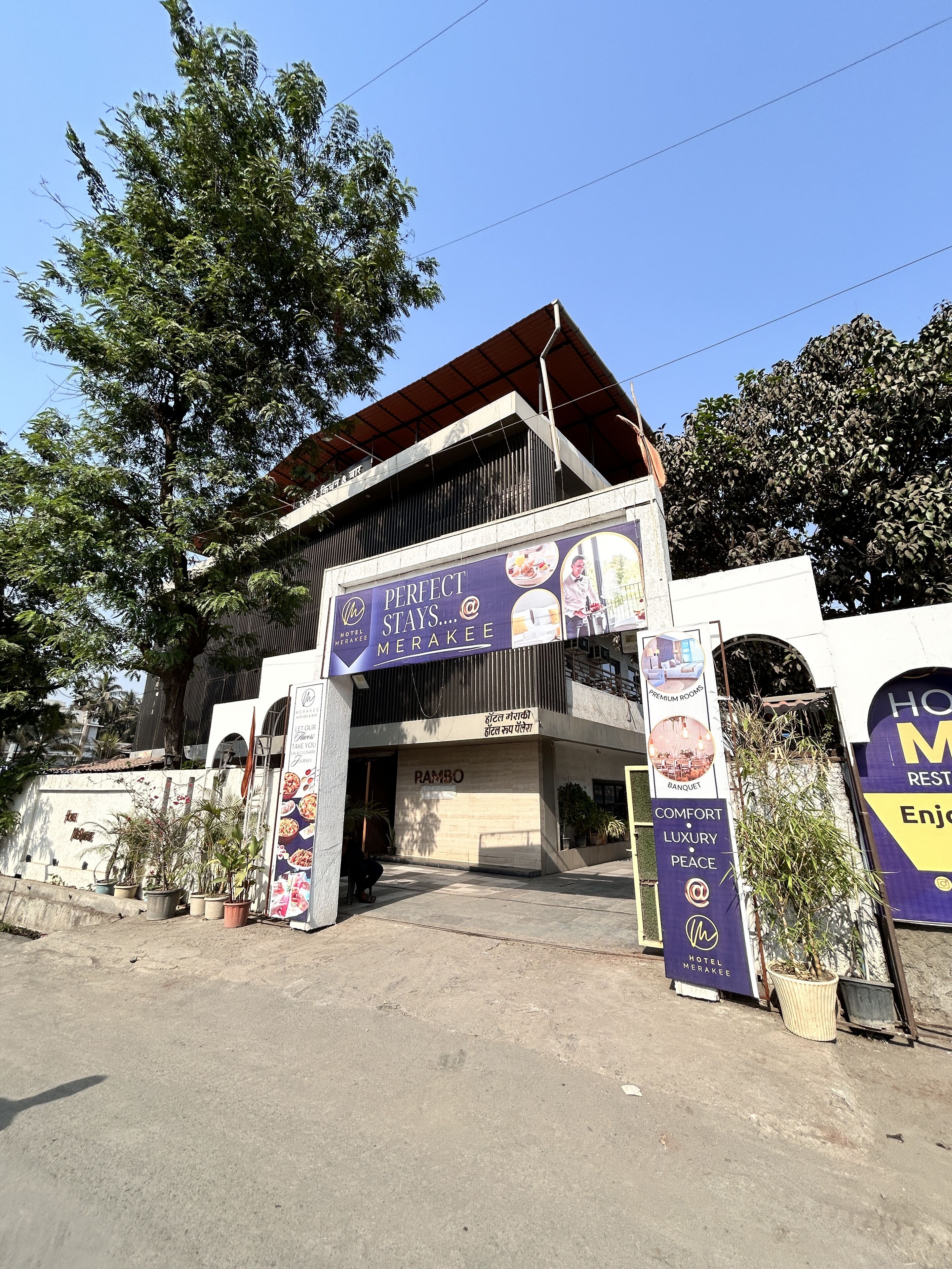 A hotel entrance with a sign reading "Perfect Stays... @ Merakee" and "Hotel Merakee."