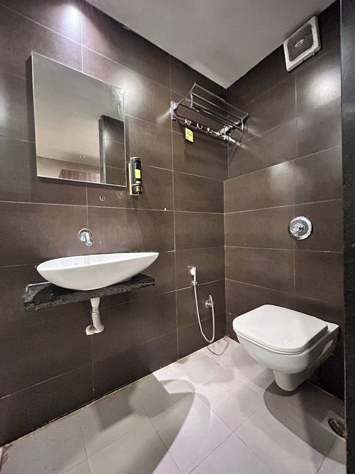 A modern bathroom with a white sink, a toilet, and a shower.