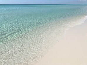 A beach with clear turquoise water and white sand. - Beach Daze - Fountain view with 2 Golf Carts! (Miramar Beach)