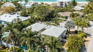 A coastal residential area with houses, a beach, and a clear view of the ocean.