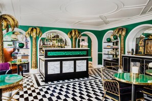 A bar area with a checkered floor, green walls, and gold accents. - The Prospect Hollywood (Los Angeles)