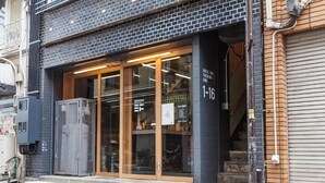 A storefront with large glass doors, a wooden frame, and a sign indicating the number 1-16. - Area Inn Fushimicho Fukuyama Castle Side 2-8 - Hostel (Fukuyama)