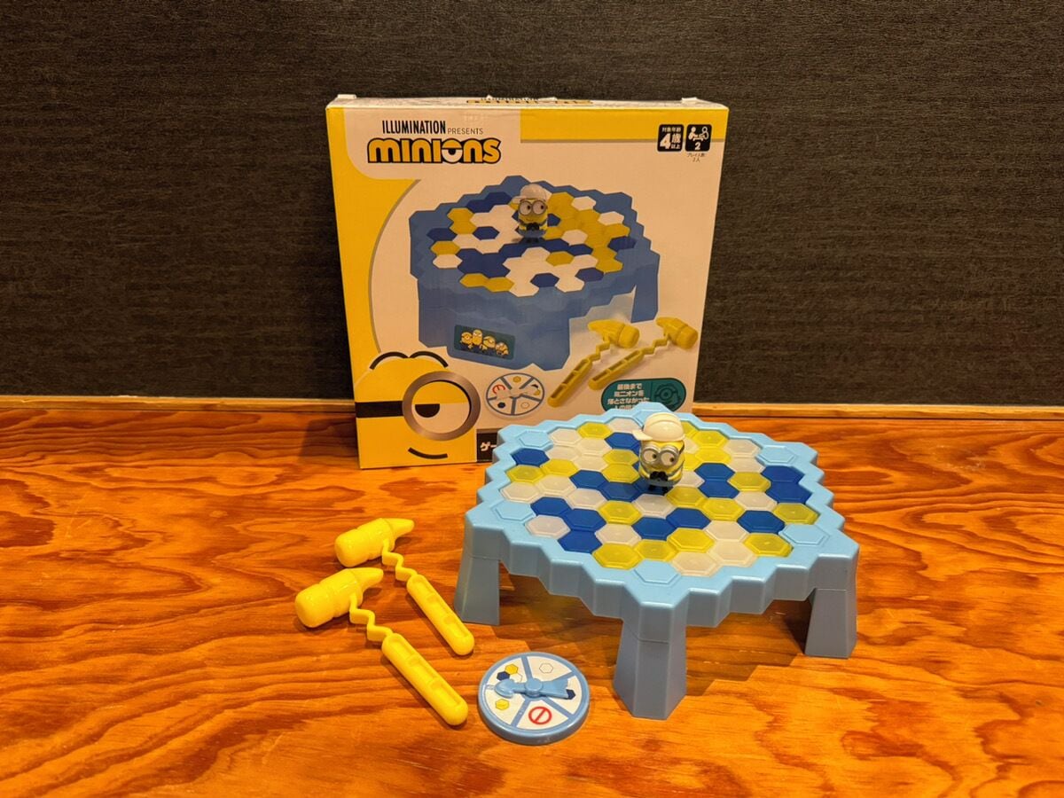 A game set on a wooden table with a box in the background.