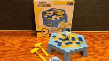 A game set on a wooden table with a box in the background.