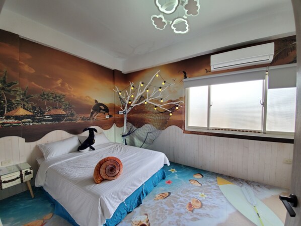 A bedroom with a mural of a tropical scene, a bed with a white and blue bedspread, a nightstand, and a window with blinds.