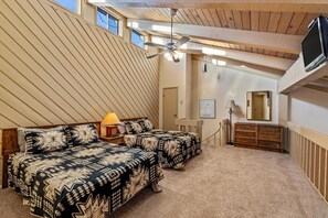 A bedroom with two beds, a ceiling fan, a TV, and a dresser. - ⭐️ 2 Level Unit w/ Pool ⎮Hot Tubs ⎮Private Deck (Steamboat Springs)