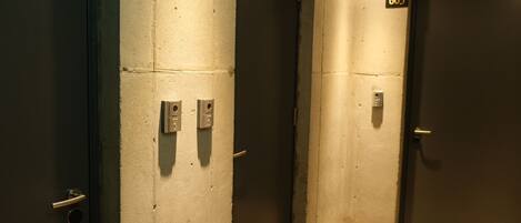An elevator area with three doors, each marked with a number.