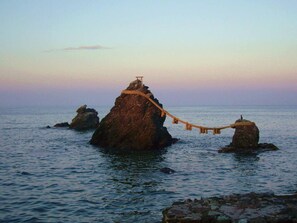 A rock formation with a rope bridge and a wooden structure on top. - Misaki Kanko Hotel (Muroto)