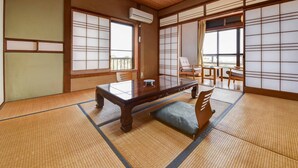 A traditional Japanese room with tatami flooring, a low wooden table, and sliding shoji screens. - Misaki Kanko Hotel (Muroto)